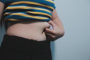 A woman with a belly showing off her stomach photo
