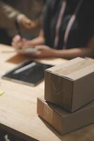 A person sitting at a desk with a laptop and a box photo
