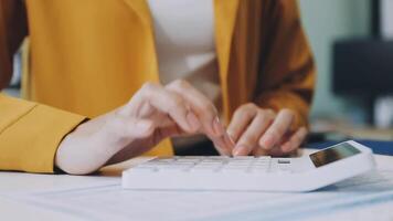 A woman is using a calculator to calculate the amount of money she has video