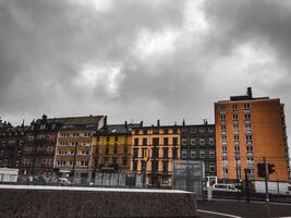 A city skyline with a cloudy sky and a few buildings photo