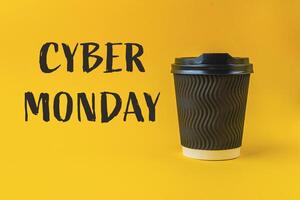 A coffee cup with a black lid sits on a yellow background photo