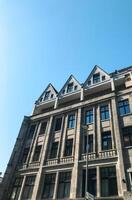 Large building with three stories and a blue sky in the background photo