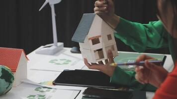 A woman is holding a model house on a table video