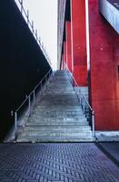 Staircase is shown in front of a red building photo