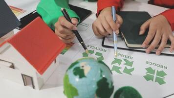 Two people are working on a project with recycling symbols video