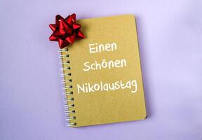 Notebook with a red bow on top photo