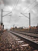 A train track with a cloudy sky in the background photo