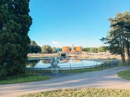 A large body of water is surrounded by trees and a building photo