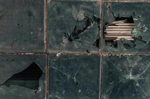 A broken window with a hole in it photo