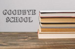 A stack of books with the word Goodbye School written on top photo