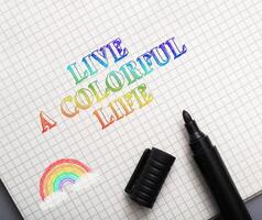 text in a notebook live a colorful life photo