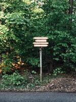 A signpost with four arrows pointing in different directions photo