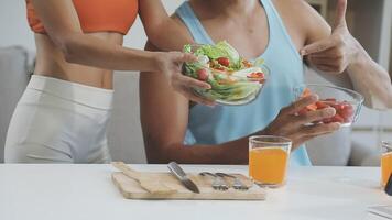 A man and woman are eating salad and drinking juice video