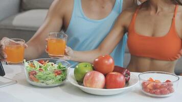 A man and woman are toasting with juice and fruit video