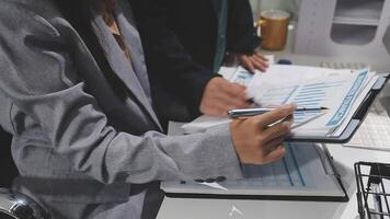 Business people working at desk with papers and pen video