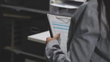 A person holding a clipboard in front of a desk video
