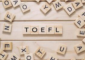 The image is a collage of wooden blocks with the letters T, O, E, F, and L photo