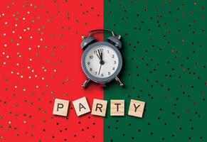 Clock is on a green background with the word party written below it photo