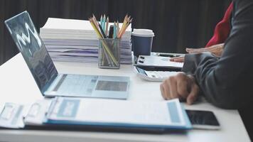A person sitting at a desk with a laptop and papers video