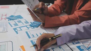 Two people working on a project with blueprints video
