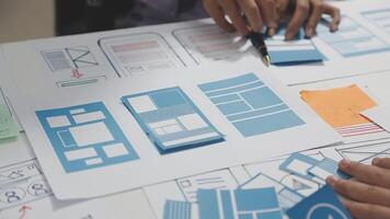 A person is working on a design document on a table video