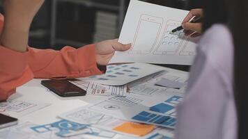 Two people working on a design document at a table video