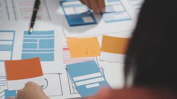 A person is working on a design project with paper and pencils video