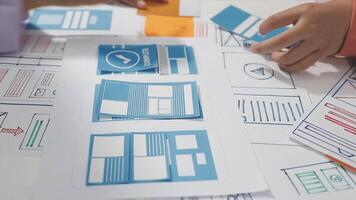 A person is working on a design project with paper and blue paper video