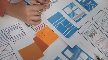 A person is working on a design project with a pen and paper video