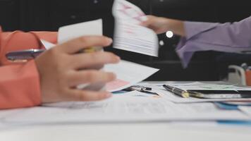 A person is holding a piece of paper while another person is holding a pen video