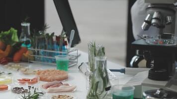 A person is working in a laboratory with various food items video