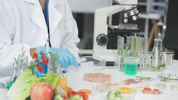 A person in a lab coat is working with food video
