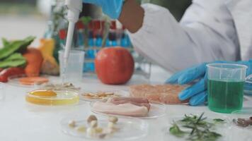A person in a lab coat is working with food video
