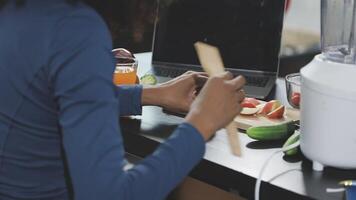 A woman is using a blender to make food video