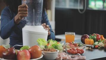 A woman is using a blender to make a smoothie video