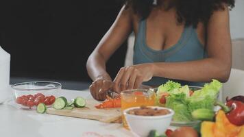 A woman is cutting vegetables and fruits on a cutting board video