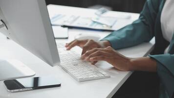 A person typing on a keyboard at a desk video