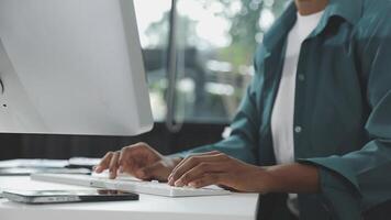 A person typing on a computer keyboard video