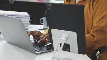 A person typing on a laptop computer video