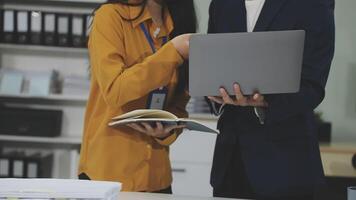 Two people standing in front of a laptop computer video