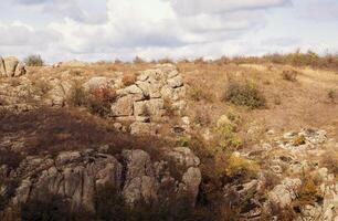fantastic autumn in a mountain canyon, huge rocks. Mountains of large granite boulders, stone ledges for mountaineering and walking. trees grow among the rocks. Aktovsky Canyon, Ukraine. photo