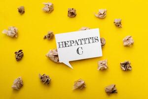 Yellow background with a white sign that says Hepatitis C photo