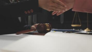 A judge shaking hands with a lawyer and a gavel video