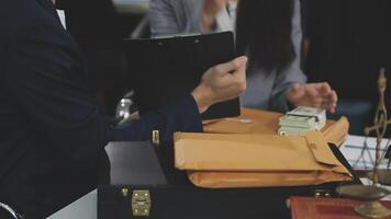 A man and woman in business attire are sitting at a desk video