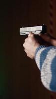 Vertical Firing range customer doing shooting activity with pistol, checking if he shot bullseye. Close up of person in shooting gallery learning how to use firearm, analyzing targets shot, camera A video
