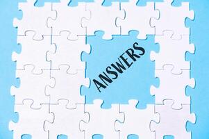 Puzzle with the word answers written in black on it photo