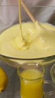 Whisking cake batter in a glass bowl, in the process of baking a cake. video