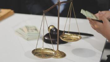 A person holding money on a scale with a balance scale video