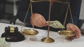 A woman holding money on a scale with a judge video