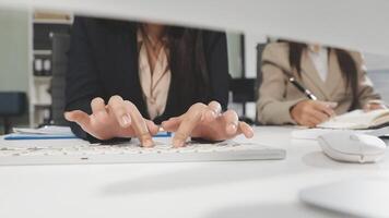 A woman in a business suit is typing on a keyboard video